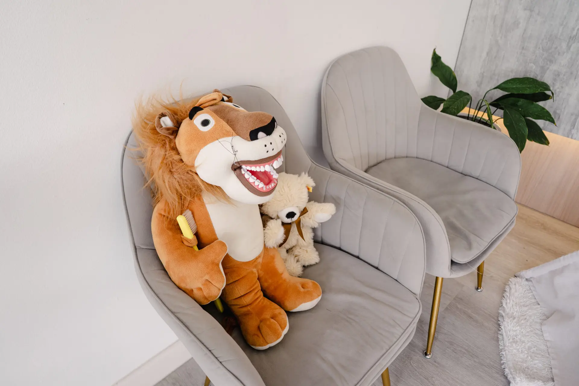 Child-friendly seating area at Oralis Dental with plush toys and modern chairs, creating a cozy and playful atmosphere.