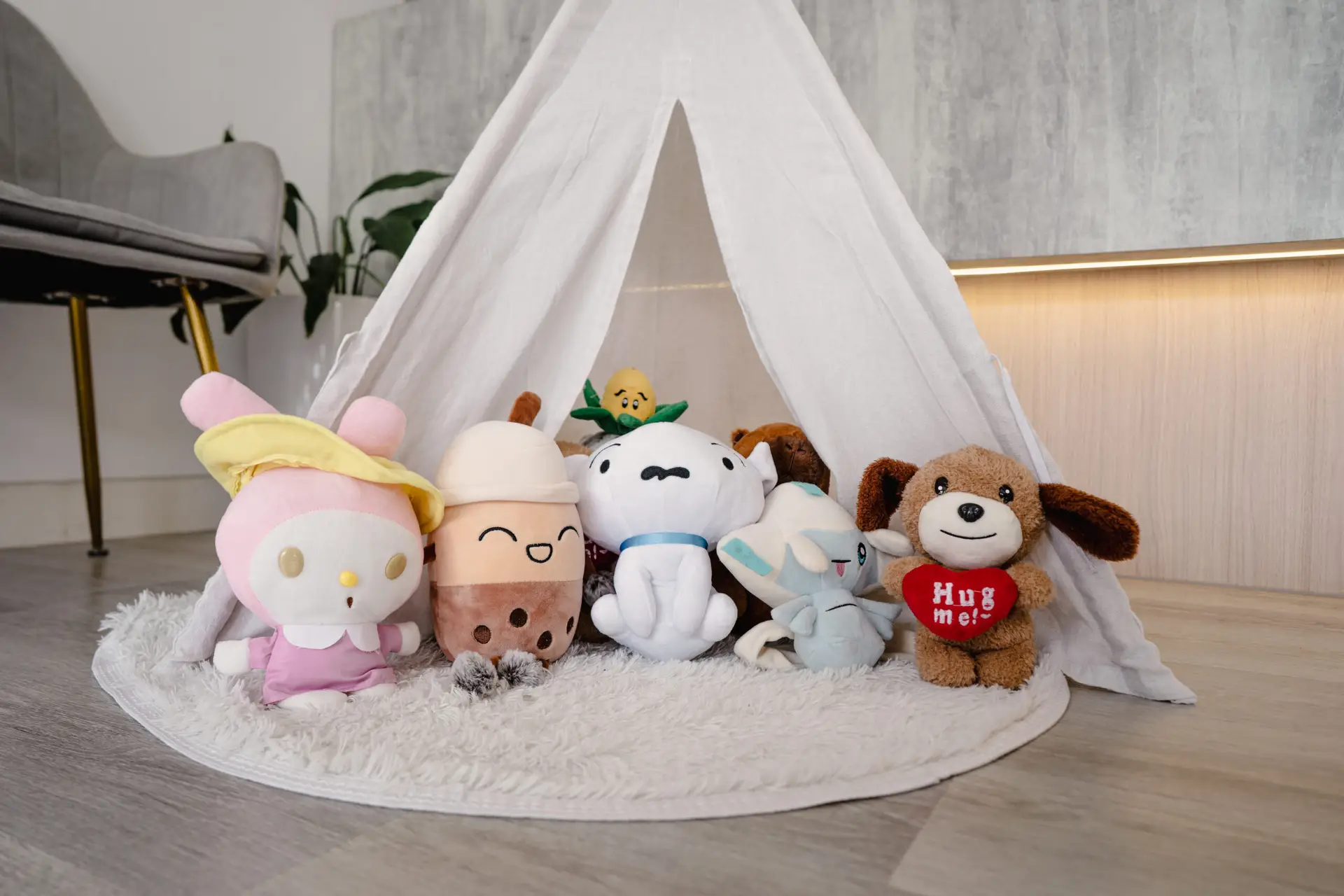 Whimsical play area at Oralis Dental with plush toys and a white teepee tent, designed to comfort young patients.