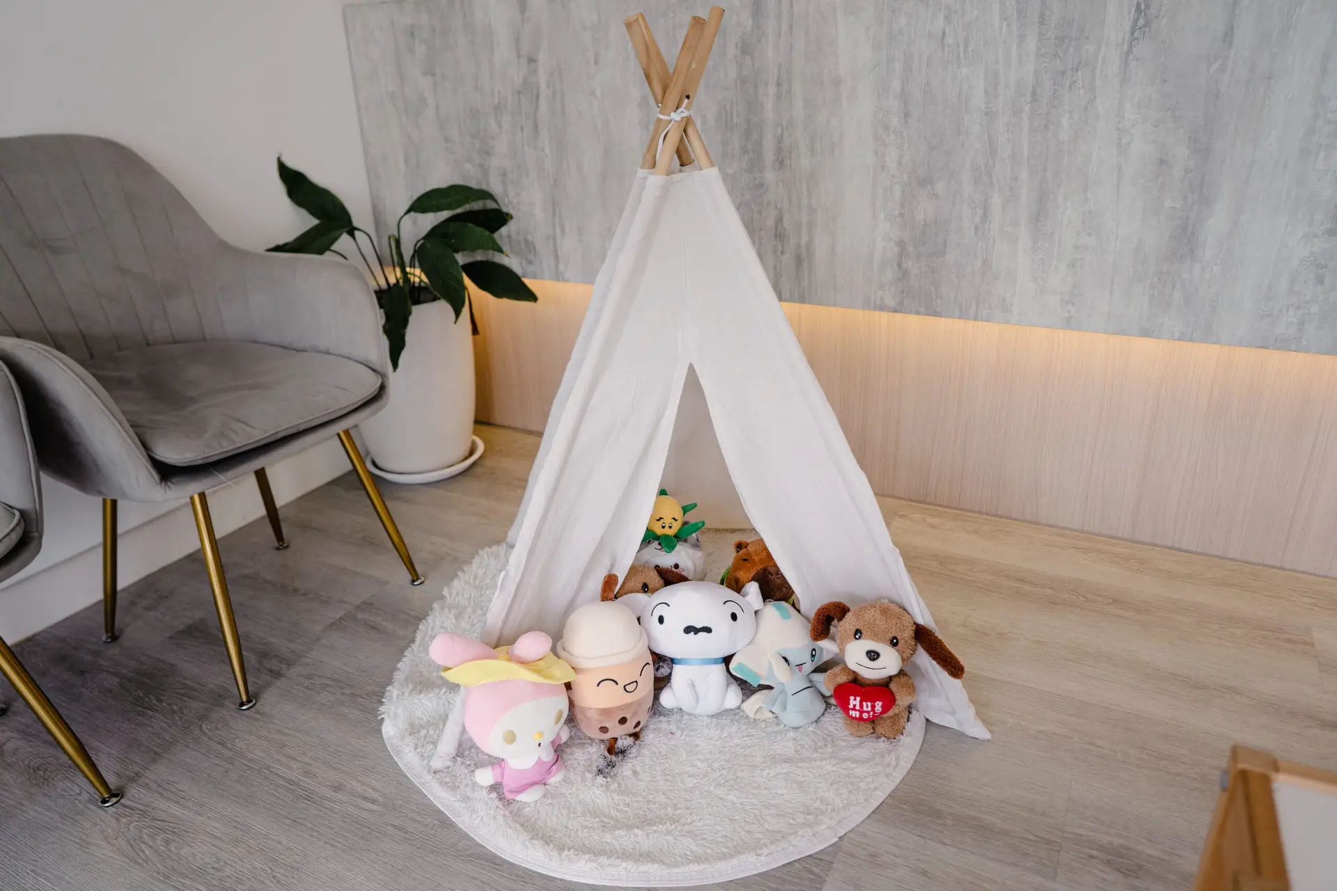 Child-friendly play area at Oralis Dental in Petaling Jaya, featuring plush toys and a cozy teepee tent for young patients.