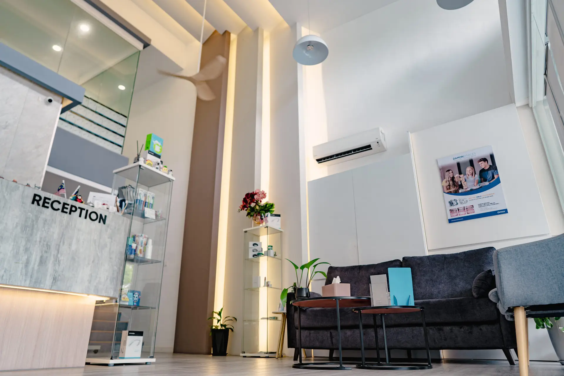 Bright and cozy waiting area at Oralis Dental, with comfortable seating, decorative touches, and large windows.